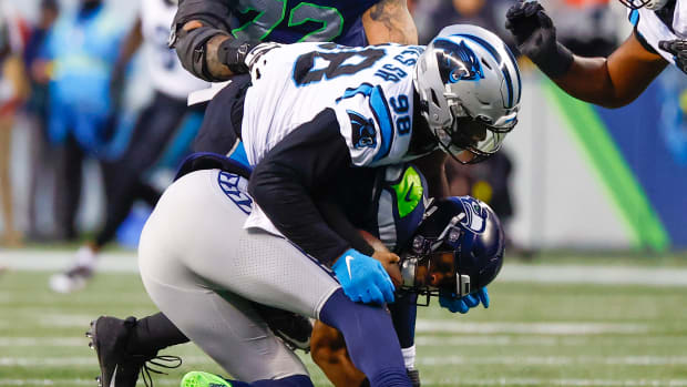 Carolina Panthers defensive end Marquis Haynes Sr. (98) sacks Seattle Seahawks quarterback Geno Smith (7) during the fourth quarter at Lumen Field.